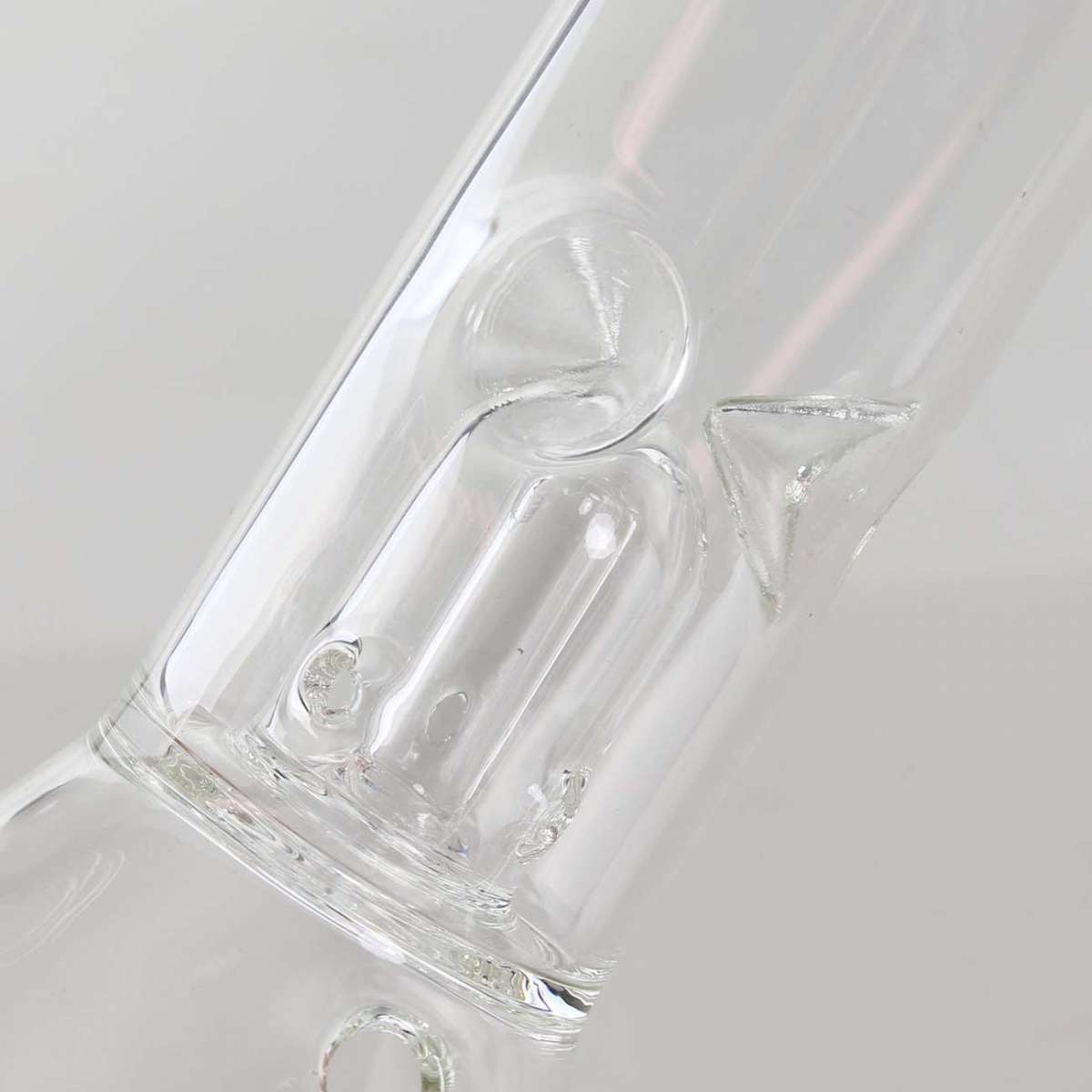 Clear glass water bong with a unique design on a white background