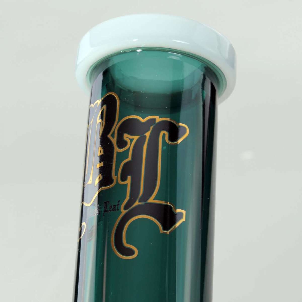 Top of a green bong with gold lettering on a light gray background