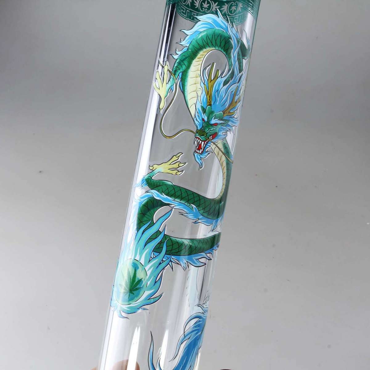 Glass bong with a green dragon design on a white background