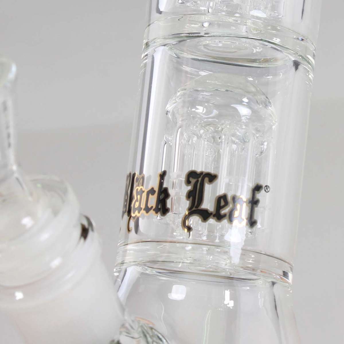 Clear glass bong with 'Black Leaf' branding on a white background