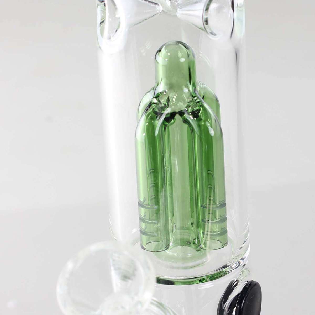 Glass smoking bong with a green bottle insert on a white background