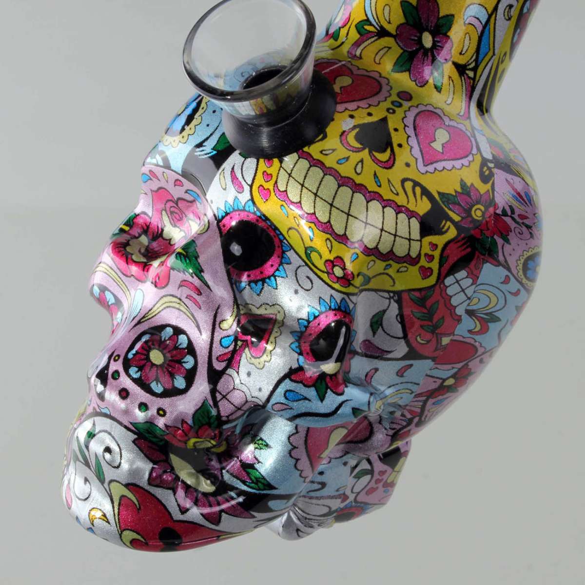 Colorful skull-shaped bong with floral and decorative patterns on a gray background