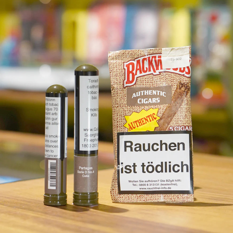 Pack of Backwoods cigars with two cigars on a wooden surface, blurred background